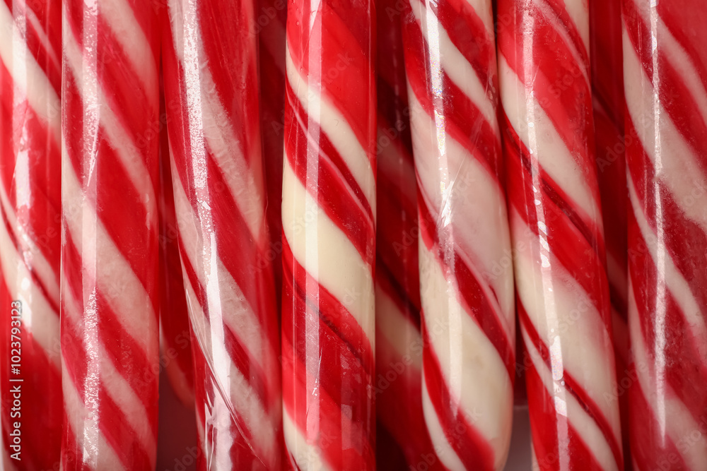 Texture of tasty Christmas candy canes as background, closeup