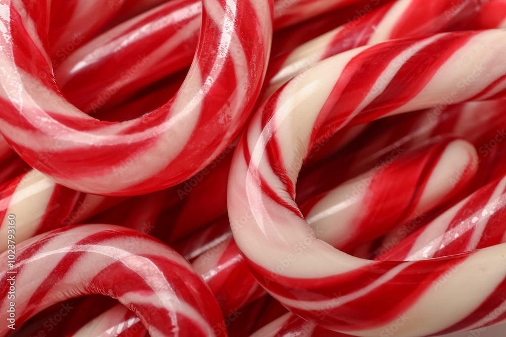 Texture of tasty Christmas candy canes as background, closeup