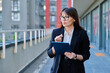 © Valerii Honcharuk - Mature woman manager agent using digital tablet for work, city background