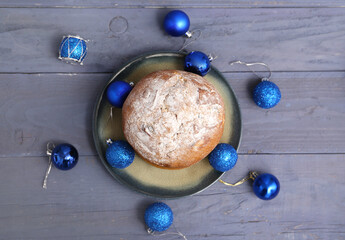 Poster - Plate with tasty Panettone and Christmas decor on blue wooden background