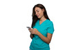 © PeopleVideos - Portrait of a young nurse in scrubs using a smartphone