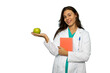 © PeopleVideos - Portrait of a young female doctor in a lab coat holding a green apple