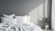 © Elshad Karimov - Mockup of empty bedding items. Front view of bed linen on a white bed against a gray wall. Pillows, duvet, and bed sheet in an empty room. Clipping path included.