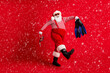 © deagreez - Full length photo of grandfather grey beard go hold blue gear mask fins wear santa claus x-mas costume suspenders sunglass striped shirt cap boots isolated red color background