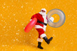 © deagreez - Full size profile side photo of white grey hair bearded santa claus rest x-mas christmas time go hold rubber circle wear sunglass headwear boots isolated bright shine color background