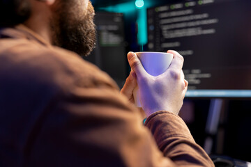 Poster - it developer drinking coffee while fixing vulnerabilities in software enabling hackers to compromise