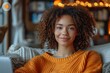 © Matvejs - Cheerful woman enjoys online browsing in her cozy modern apartment with a bright smile