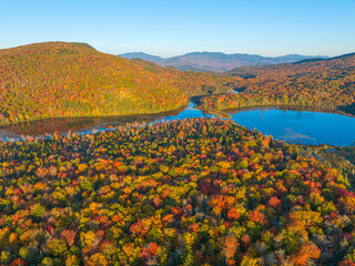 Wall Mural - aerial view of colorful autumn mountain forest and pond