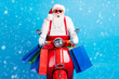 © deagreez - Amazed white grey hair bearded santa claus drive motorbike shooping mall hold bags x-mas christmas season tradition bargain wear red costume suspenders overalls isolated blue color background