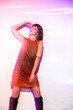 © ADDICTIVE STOCK - Retro-inspired woman bathed in colorful lights