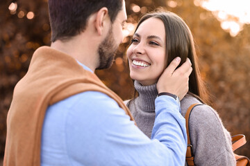 Wall Mural - Beautiful couple spending time together outdoors on autumn day