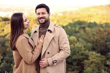 Poster - Beautiful couple spending time together outdoors on autumn day, space for text