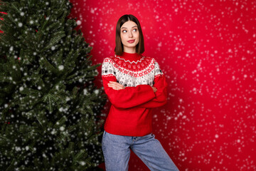 Photo of cute pretty young lady wear print sweater arms crossed looking empty space isolated red color background