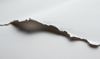 Wall Mural - A white paper with a tear in it