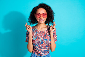 Poster - Photo portrait of pretty young girl sunglass crossed fingers hope wear trendy colorful clothes isolated on aquamarine color background