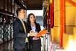© CandyRetriever  - Asian businessman and businesswoman warehouse manager meeting and discussion during working in distribution fulfillment center. Business industry, Freight transportation and logistic cargo concept.