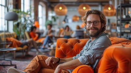 happy man relaxing in stylish cafe with orange decor
