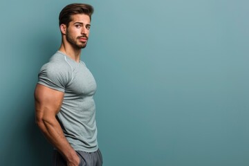 Wall Mural - Fit man with a strong body and a sharp mind, standing against a solid color backdrop, perfect for gym marketing that highlights total body and mind fitness
