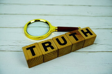 Aufkleber - Truth with wooden blocks alphabet letters and magnifying glass top view on wooden background