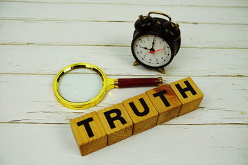 Aufkleber - Truth alphabet letters with magnifying glass and alarm clcok top view of wooden background