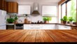 © Oranuch - Wooden tabletop in a modern kitchen setting with plants and natural light.