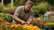 © Pannee - Gardener Pruning Flowers in a Colorful Garden