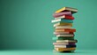 © Rstm - A stack of colorful books on a green background.