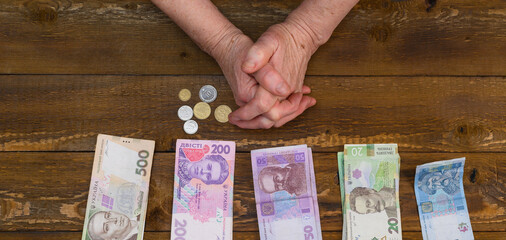 Money in the hands of an elderly woman close-up.