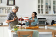 © pixs4u - Senior Couple Celebrating with Homemade Cake in Kitchen
