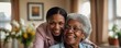 © Muqaddas - Happy senior black woman in a nursing home. Smiling old african american female pensioner being cared for by a nurse