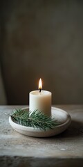 Canvas Print - A candle is lit in a white bowl with a green leaf on top. The candle is the main focus of the image, and the leaf adds a touch of nature to the scene