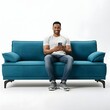 © elwa - A casually dressed man sitting on a modern blue sofa, holding a smartphone and smiling, with a plain white background. Ideal for tech, lifestyle, and home decor themes