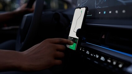 A taxi or ride-share driver uses an app to accept a passenger request. The phone screen shows a map and route, demonstrating the app's functionality for managing rides and navigating efficiently
