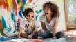 © Oulaphone - A joyful mother and son share a playful moment, covered in paint, surrounded by vibrant colors on a wall and floor, capturing a fun artistic experience together.