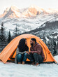 © Studio-FI - young couple wild camping in the snowy mountains having fun and keeping warm together on a trekking holiday