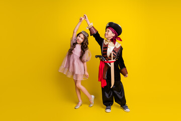 Canvas Print - Full size photo of two little kids dance halloween pirate princess costume isolated on yellow color background