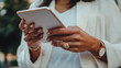 © Wankhairulizuan - Close-up of hands holding a digital tablet, ready for browsing or reading.