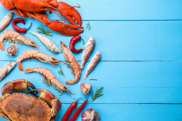 Poster - Different sea food on light blue wooden table, flat lay. Space for text