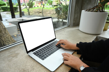 Cropped shot of young woman freelancer working with laptop at cafe