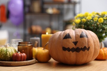 Poster - Halloween celebration. Pumpkin with creepy face, flowers and candles on wooden table