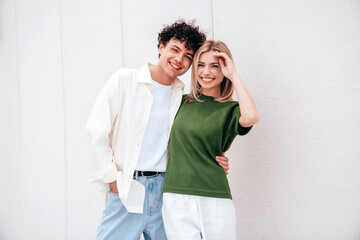 Canvas Print - Smiling beautiful woman and her handsome boyfriend. Couple in casual summer clothes. Happy cheerful family. Female and man having fun. They posing in the street in sunny day. Having tender moments