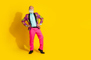 Wall Mural - Full body portrait of charismatic aged man put hands waist posing empty space isolated on yellow color background