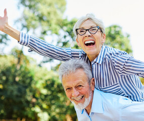 Wall Mural - woman man outdoor senior couple happy lifestyle retirement together smiling love fun elderly active vitality nature mature portrait piggyback game