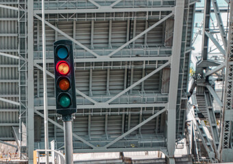 A traffic light in front of a open bridge