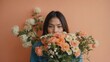 © Nemanja - Woman holding flowers in front of face, bright background