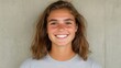 © Business Image - Portrait of a young woman smiling against concrete wall for lifestyle and fashion photography