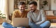© Ramesh Chavan - Handsome Gay Couple Using Laptop Computer, while Sitting on a Living Room Floor in Cozy Stylish Apartment. Adult Boyfriends Online Shopping on Internet, Watching Funny Videos on, Generative AI