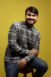 © Albino Abreu - man sitting, smiling, leaning on his left leg
