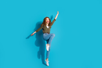 Poster - Full size photo of nice young lady jump empty space wear shirt isolated on teal color background