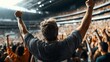© altitudevisual - A person with raised arms cheering in a crowded sports stadium with vibrant audience energy and dynamic lighting.